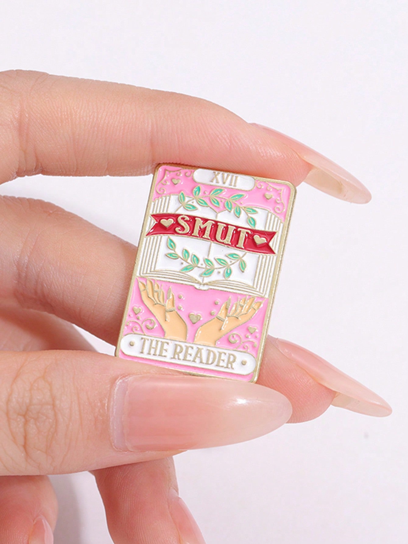 Introducing The Reader's Smut Enamel Needle - Fun Cartoon Book Brooch, perfect for book lovers everywhere! Made with high-quality enamel and featuring a playful book design, this brooch adds a touch of literary charm to any outfit. Share your love for books and add a unique accessory to your wardrobe.