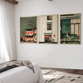 Three framed lantern, townhouse, and motorbike prints above a bedroom