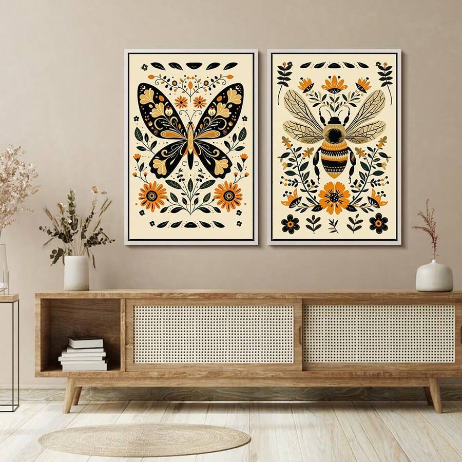 Framed monarch butterfly and bee folk art poster set above a modern sideboard