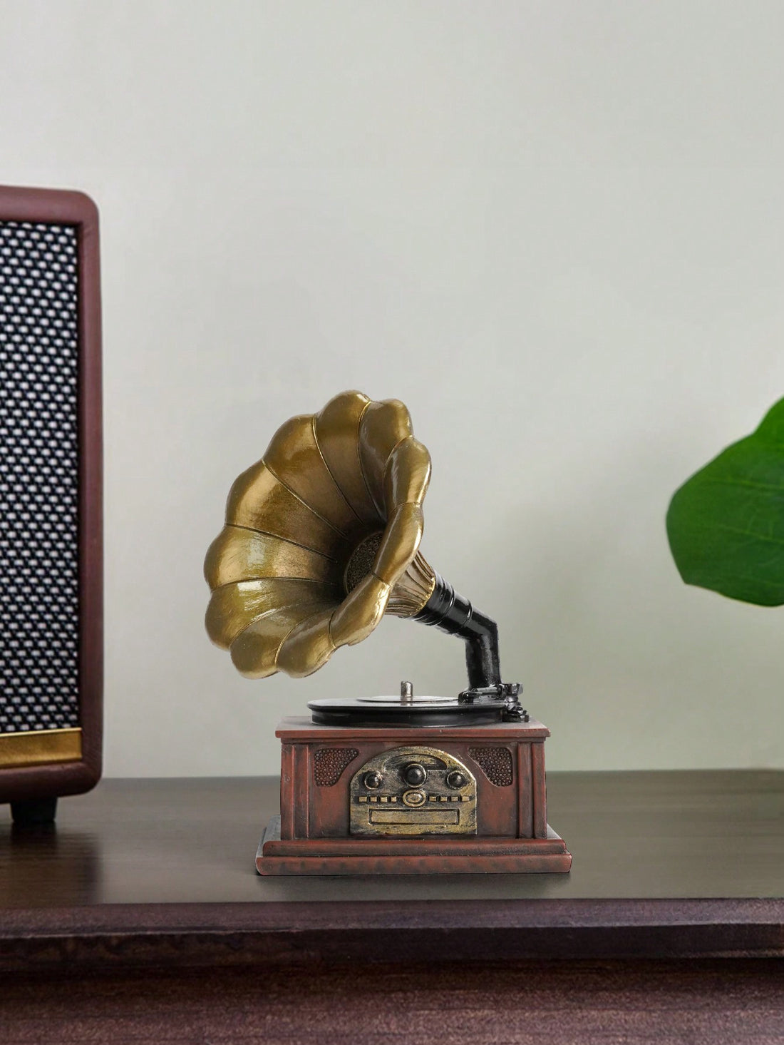 Enhance your home decor and surprise your loved ones with this Vintage Charm Phonograph Figurine. Crafted with resin, this timeless piece adds a vintage touch to any room. Perfect for music enthusiasts and collectors, this figurine makes a unique gift option.