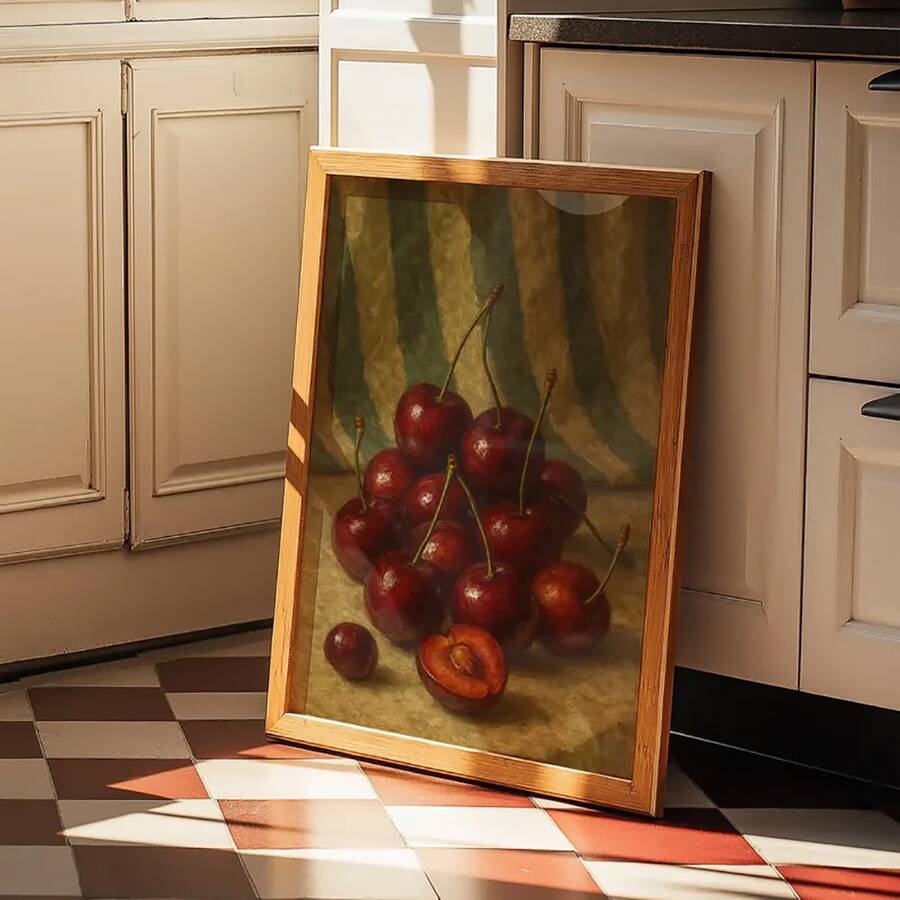 Framed still-life poster of glossy red cherries and a cut cherry on an olive-brown ground