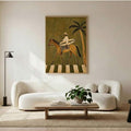 Framed coastal canvas showing a surfer carrying board on chestnut horse beneath palm tree above a neutral sofa