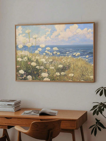 front framed view of Coastal meadow canvas wall art showing white wildflowers, ocean horizon, blue sky, soft clouds and airy impressionist cottage colors.