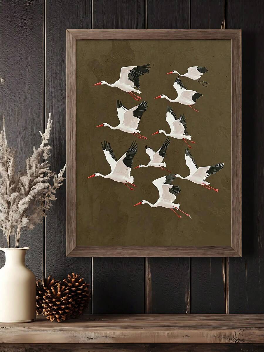 Framed stork artwork above a rustic console with dried botanicals