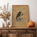 Framed raven literary artwork styled with pumpkins on a rustic sideboard