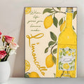 Yellow limoncello bottle and lemon branch canvas poster with handwritten lettering displayed beside a vase of pink and white roses