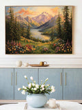 Framed alpine lake mountain painting above blue sideboard with flowers on table