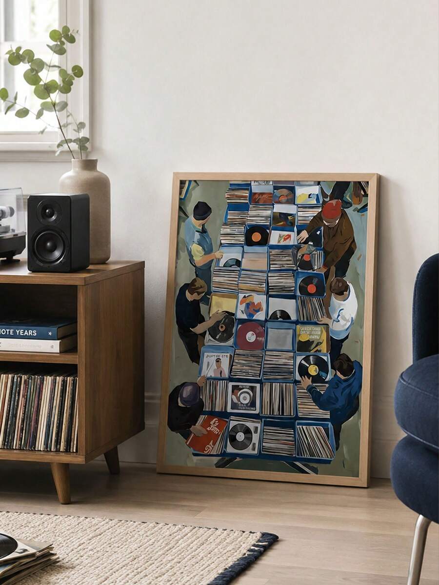 Framed vinyl market wall art leaning beside record cabinet speaker and turntable in cozy music room