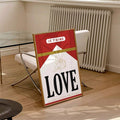 Red LOVE typography and cherub canvas poster in a bright modern room