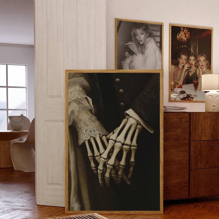Two gothic skeletal hands holding in a gold-framed romantic wall art room mockup