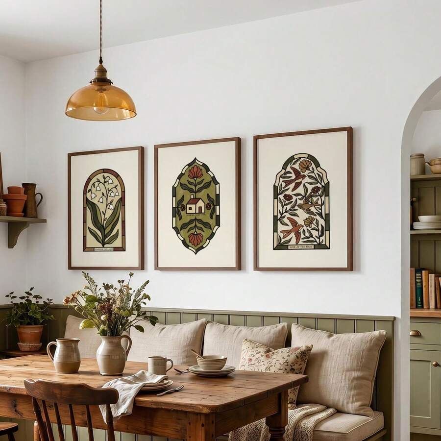 Three stained-glass-style botanical prints above a neutral dining banquette