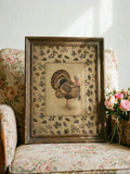 Distressed bronze framed turkey print on floral chair with pink roses