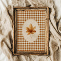 Brown autumn leaf and orange gingham wall art in a distressed rustic frame