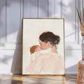 Watercolor mother and baby canvas poster in a gold frame against a paneled wall