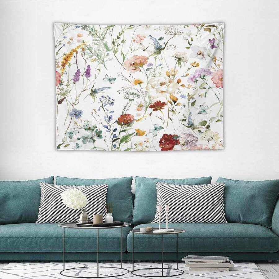 Watercolor wildflower tapestry displayed above teal sofa in bright living room