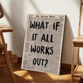 What If It All Works Out newspaper canvas leaning beside wooden furniture