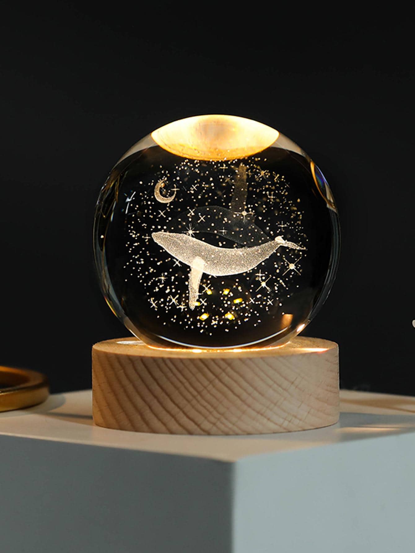 This Whimsical Whale Crystal Ball Décor is a stunning modern art sculpture that will add a touch of elegance to any home. Handcrafted with crystal clear glass, this piece features a charming whale design and a crystal ball resting on its back. Perfect for adding a touch of whimsy and sophistication to your home décor.