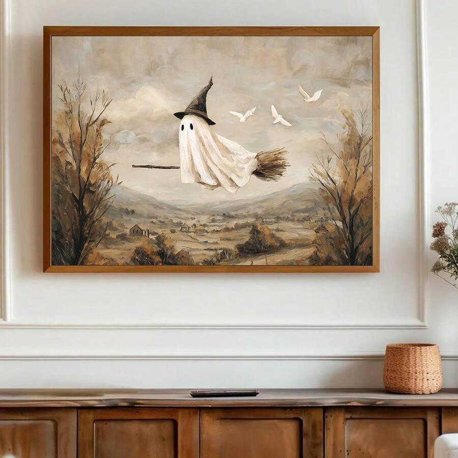 Warm wood framed flying ghost witch artwork above vintage sideboard