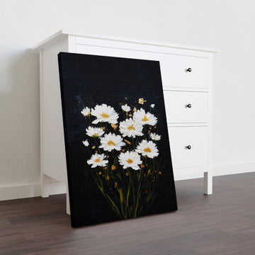 White daisies bloom against a striking black canvas, creating a sophisticated contrast that elevates any interior space. This wall art piece combines botanical elegance with modern minimalism, making it an ideal focal point for living rooms, bedroom walls, or above sofas. The crisp white florals draw the eye while the dark background grounds the composition, adding depth and visual interest without overwhelming your décor.