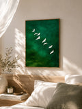 Green watercolor bird wall art above bed in neutral bedroom with sunlight