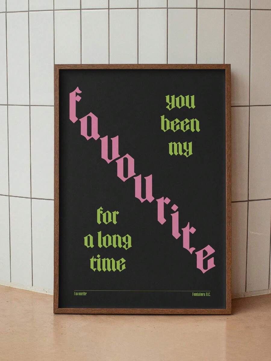 Black lyric poster with pink and lime gothic lettering leaning by pale tile